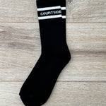 Black socks with white stripe and words courtside signature logo shown flat