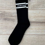 Black socks with white stripe and words courtside signature logo shown flat