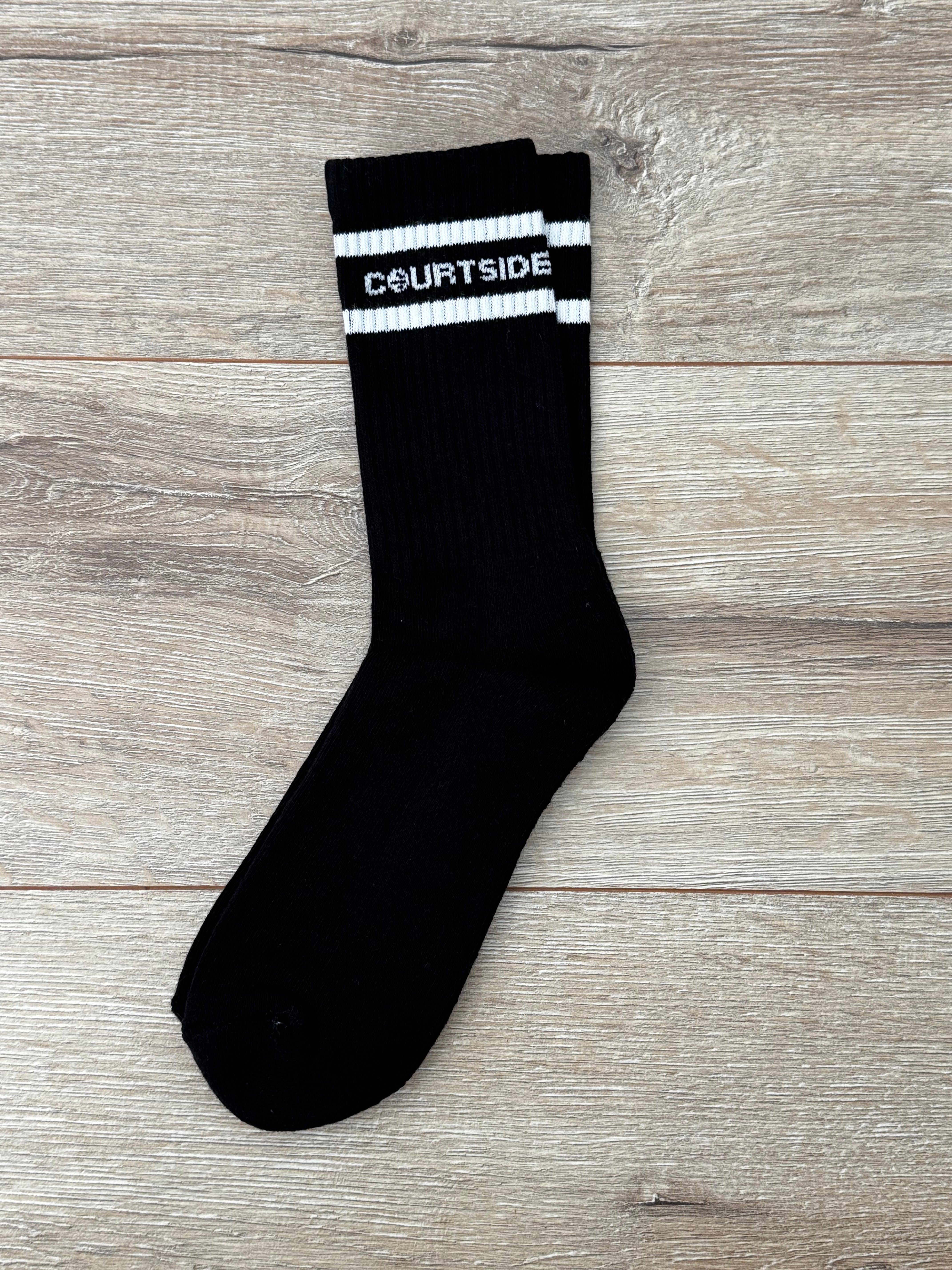 Black socks with white stripe and words courtside signature logo shown flat