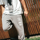 NBL Player Nelson Kahler wearing the Courtside Bench Track Pants in Faded Grey colour.