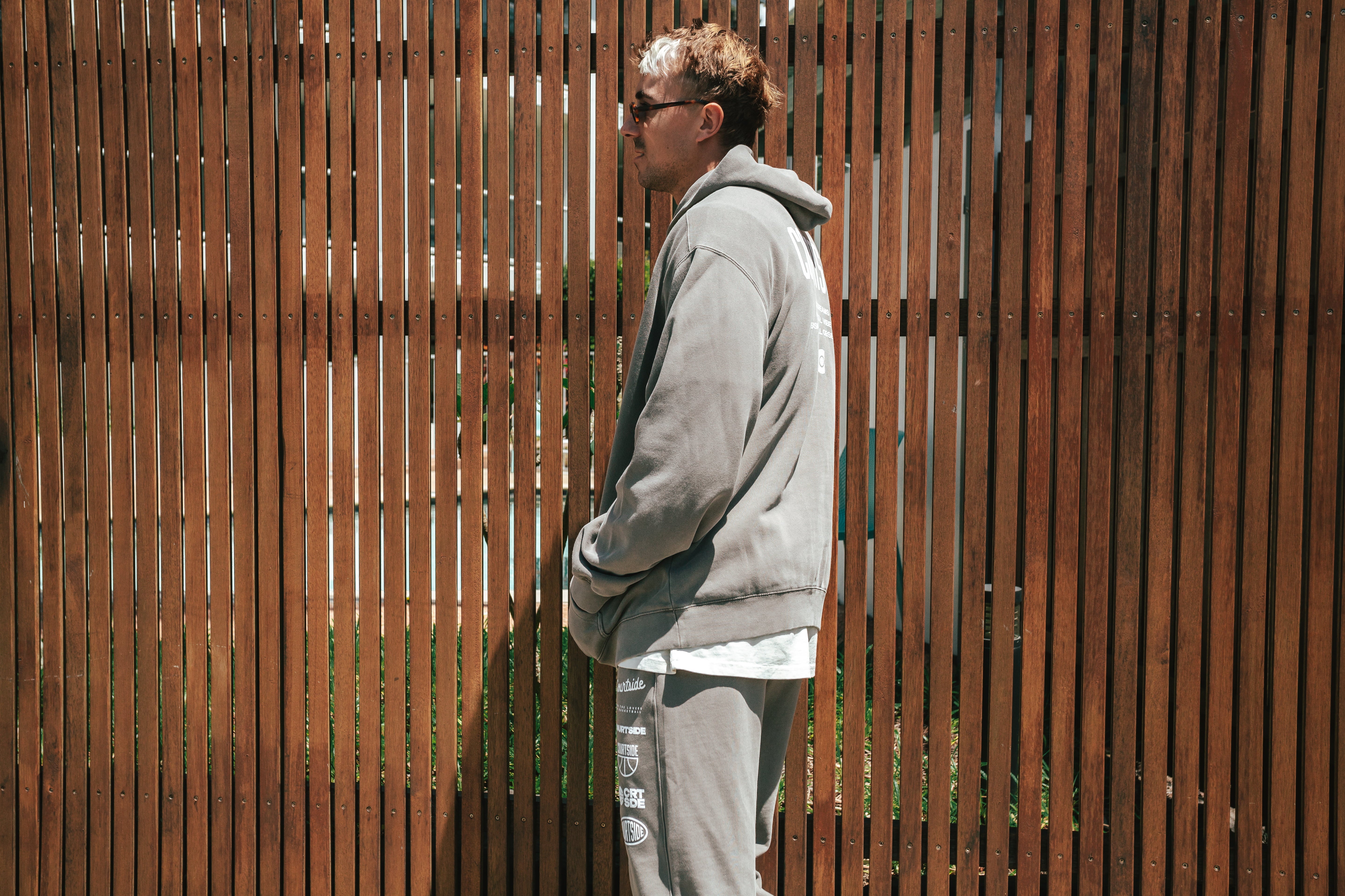 NBL Player Nelson Kahler wearing the Courtside Bench Track Pants in Faded Grey colour.