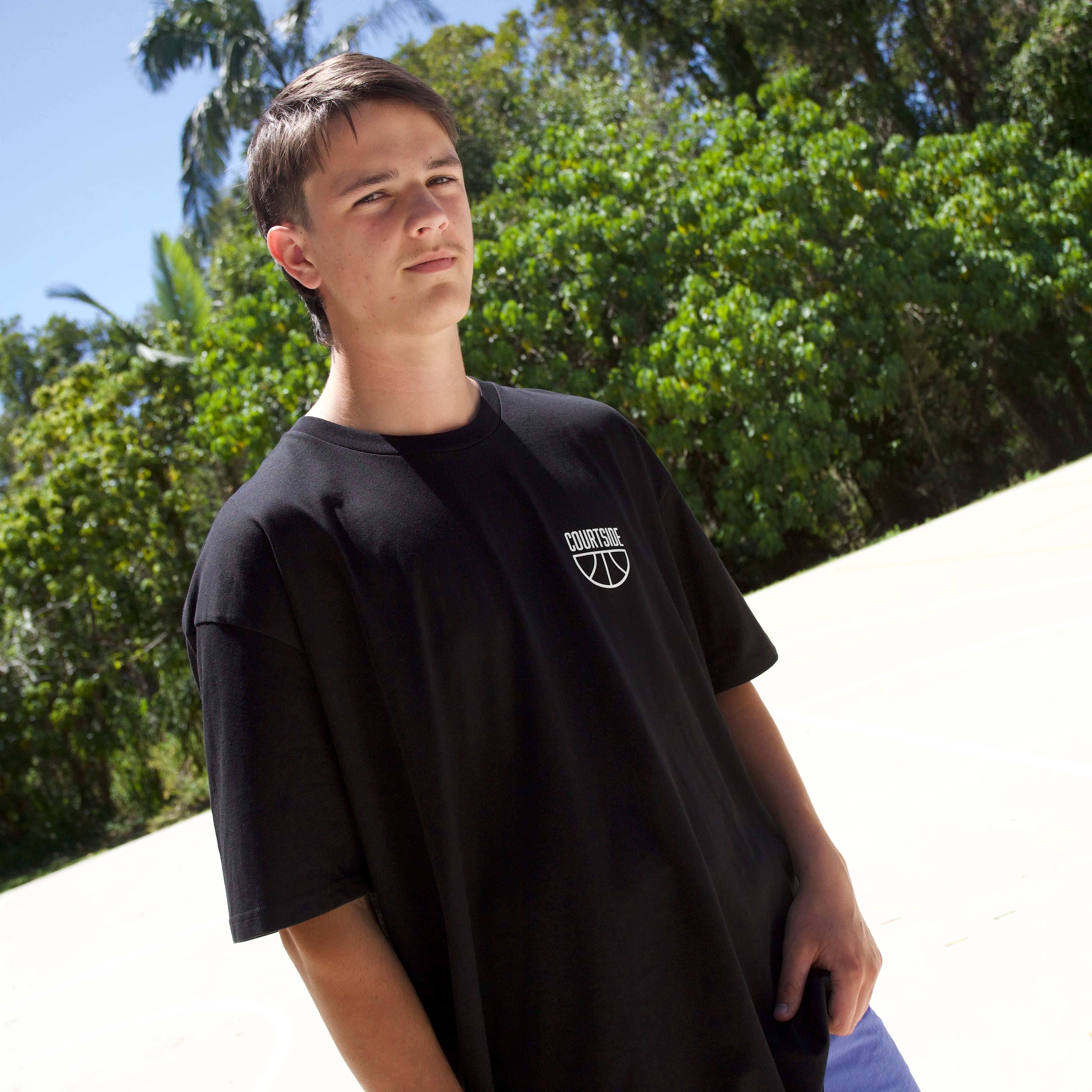 COURTSIDE black tee with white large print on back. Shown with Courtside script white hat.