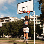 basketball player wearing champs tee shown hooping