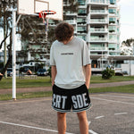 Courtside Black basketball shorts on Louis Lauret elite junior basketball player with white large letters across front CRT SDE short for Courtside with Teal detailing.