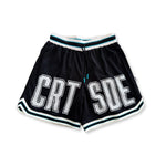 Black basketball shorts with white large letters across front CRT SDE short for Courtside with Teal detailing.