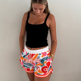 MVPW Courtside orange and white patterned short cut shorts shown on model size S
