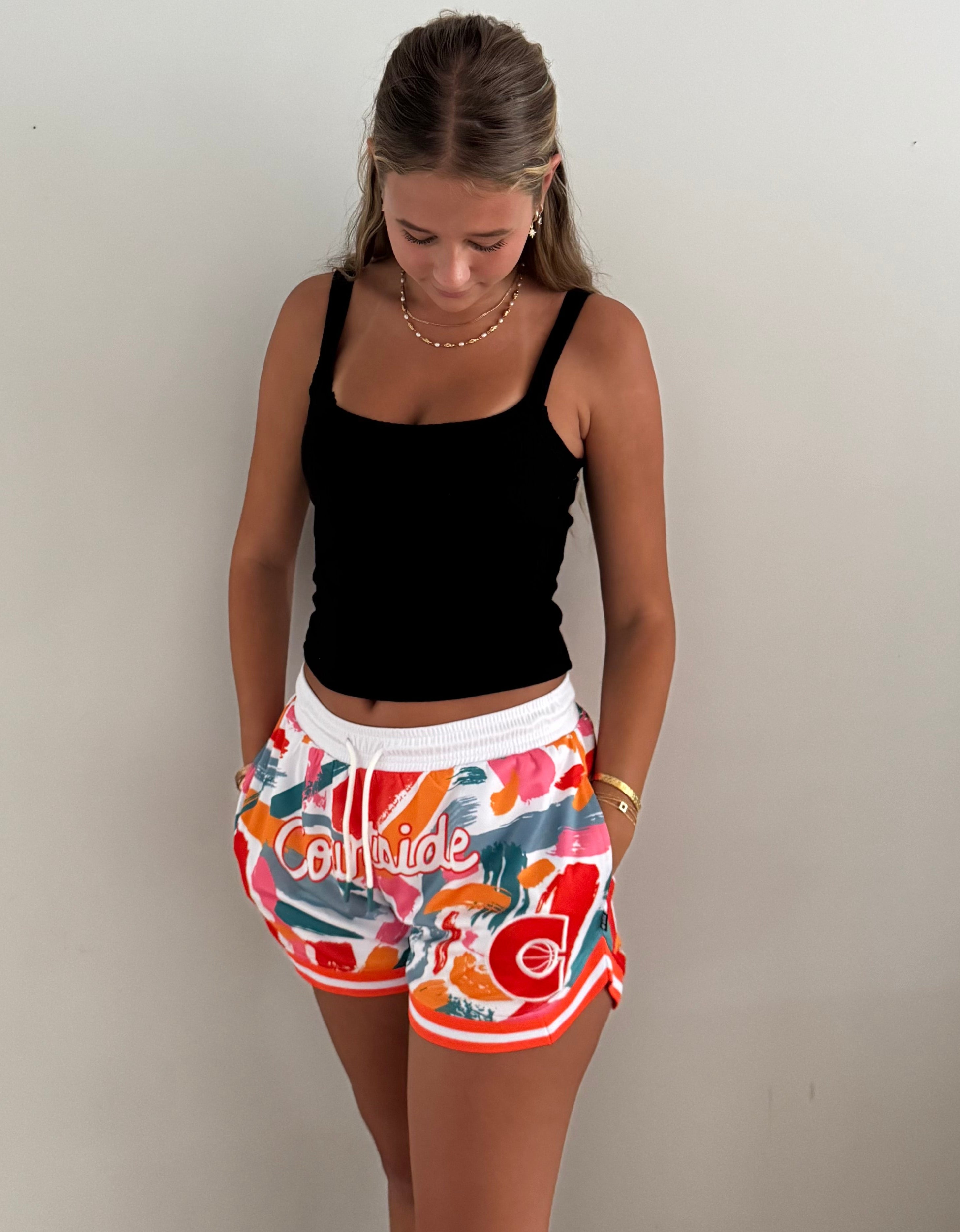 MVPW Courtside orange and white patterned short cut shorts shown on model size S