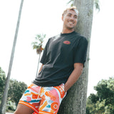Courtside MVP basketball short shown on Nelson Kahler NBL player with a black streetball tee leaning against a palm tree