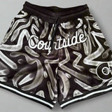 Courtside ROTY basketball shorts in white and black pattern laid flat on table with grey background