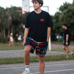 Junior elite basketball player Sam Lauret wearing Courtside ROTY black & coloured designed basketball shorts