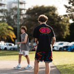players wearing courtside shorts and tees whist hooping on the streets