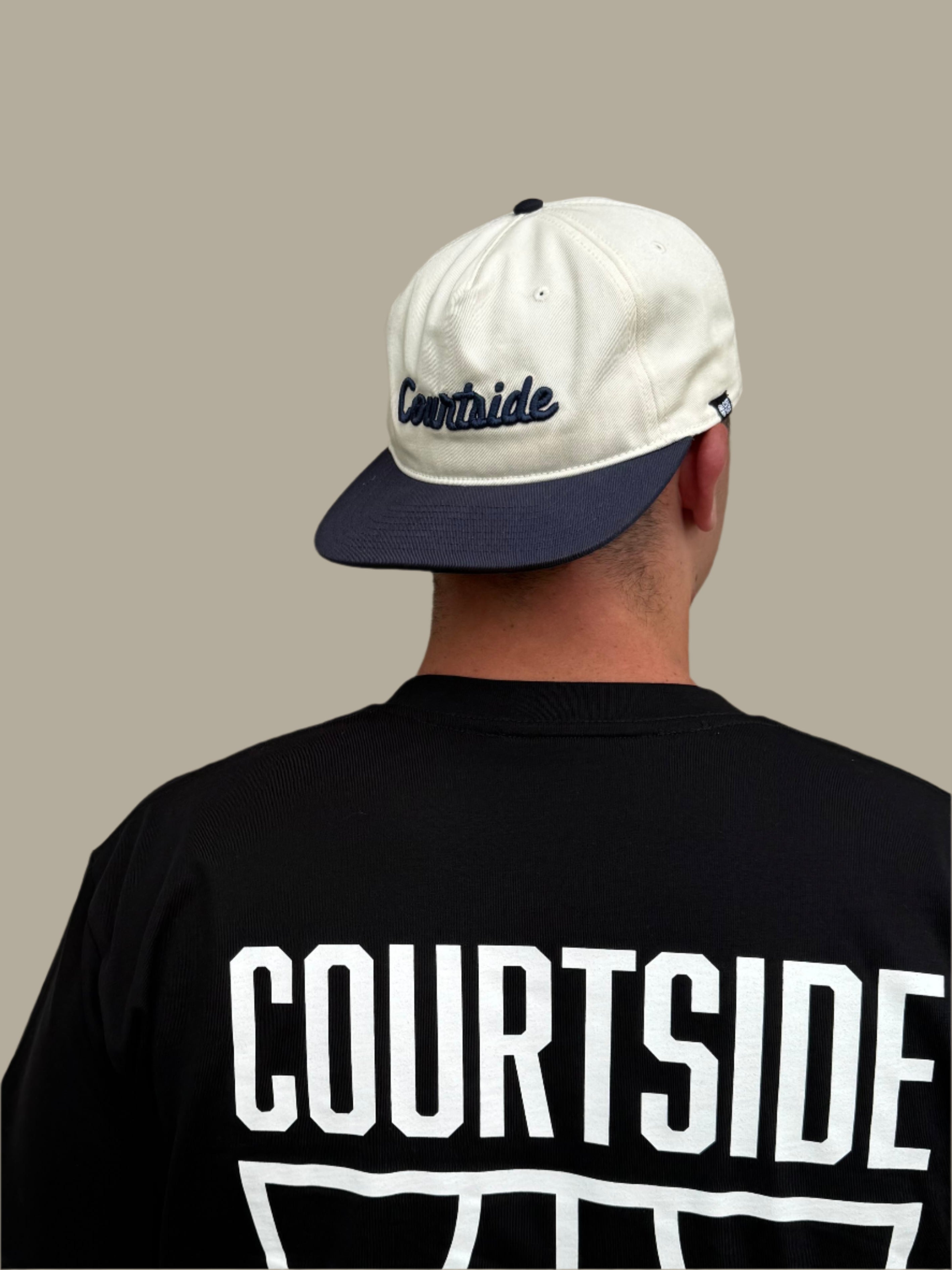 Courtside script white and navy cap showing unique style