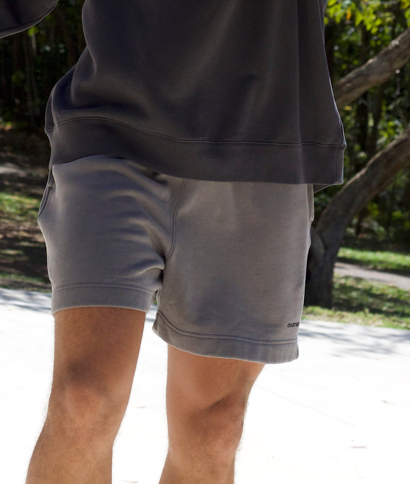 dark grey tracksuit shorts with small black courtside logo on left leg shown on basketball player