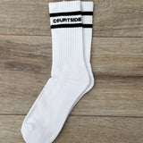 pair of white socks with courtside written along top with black stripe top & bottom