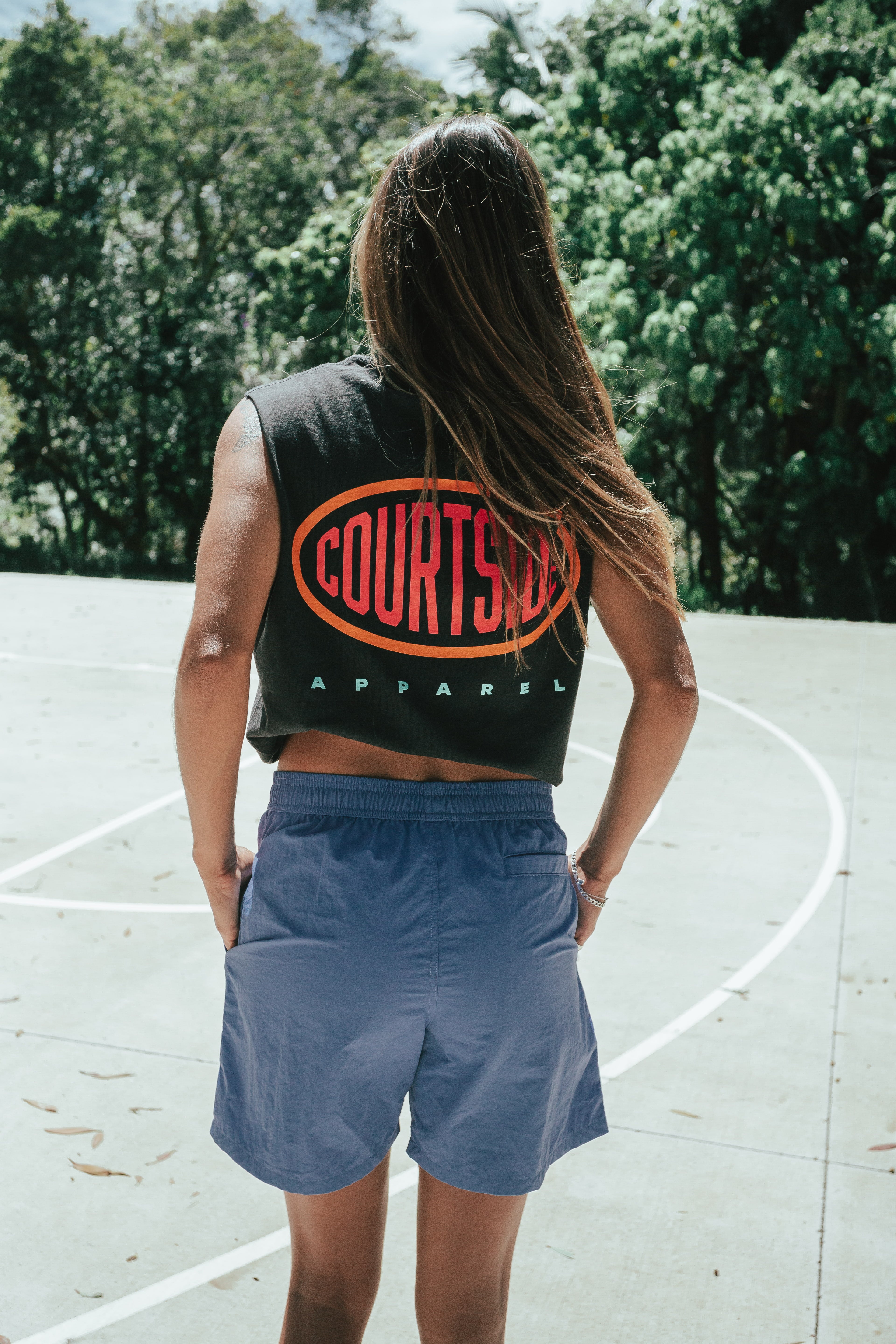Bright blue shorts shown on a female from behind, mid thigh length with side pockets.