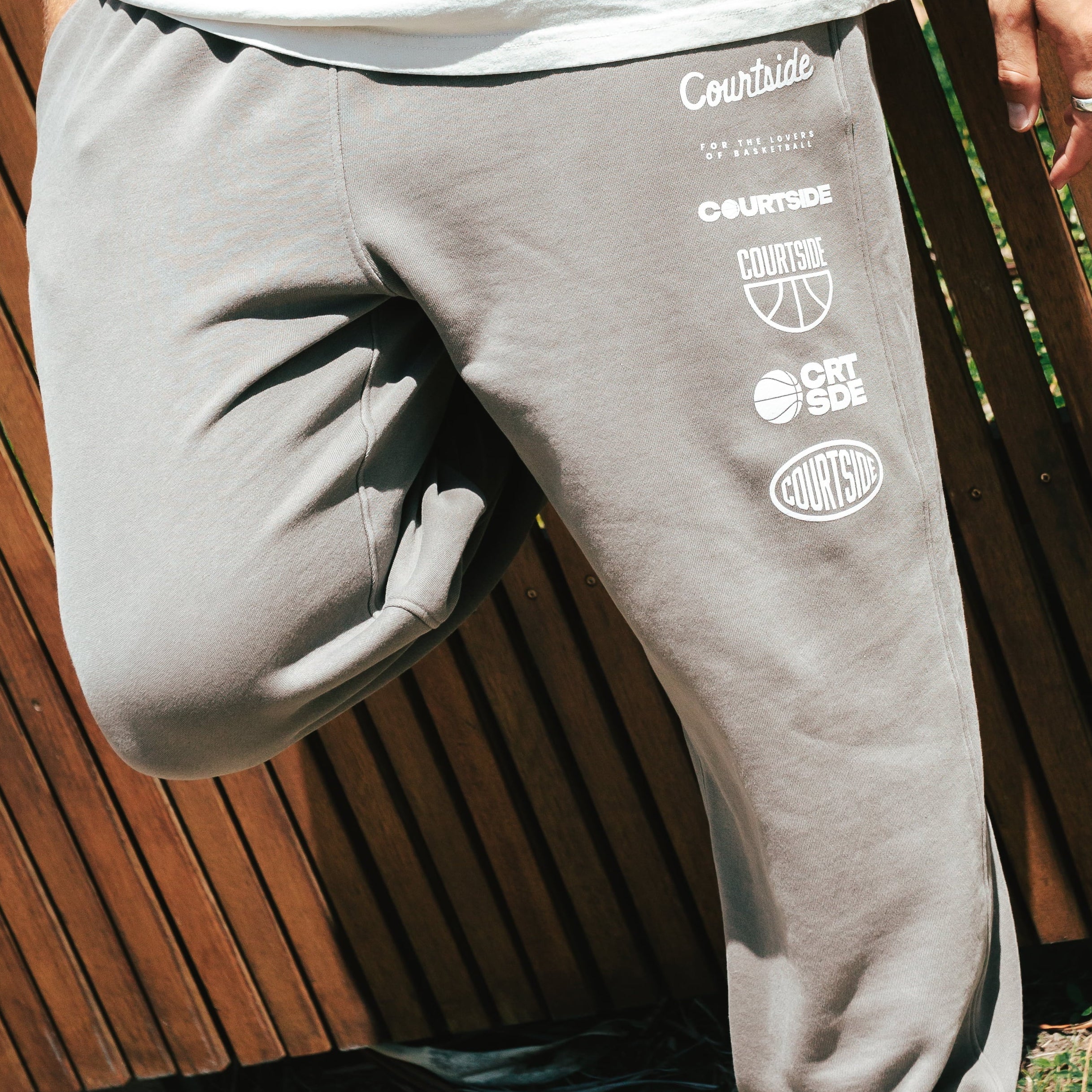 NBL Player Nelson Kahler wearing the Courtside Bench Track Pants in Faded Grey colour.