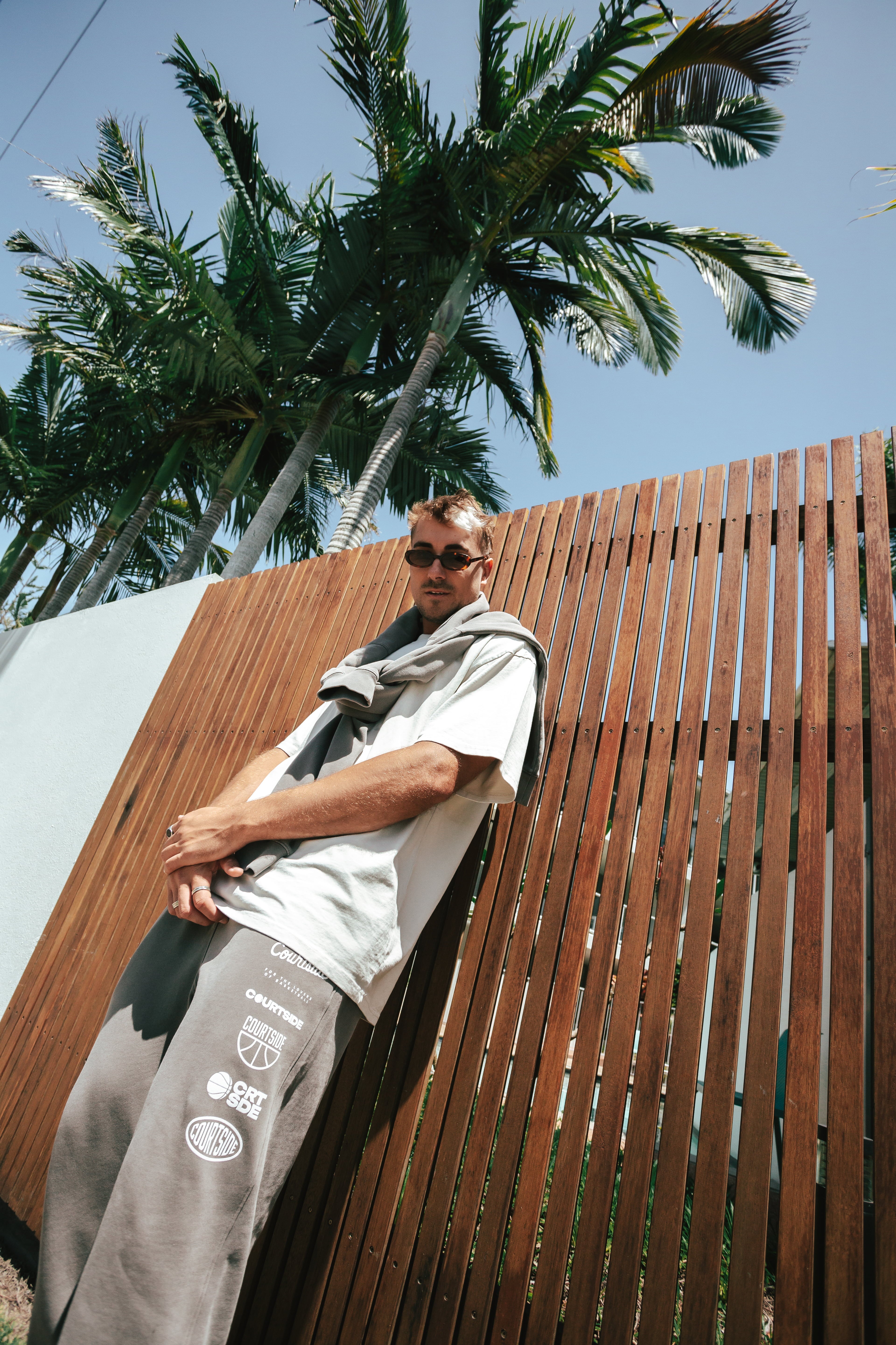 NBL Player Nelson Kahler wearing the Courtside Bench Track Pants in Faded Grey colour.