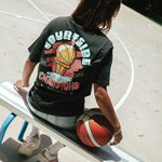 Gabi wearing the Courtside Champs Tee in Faded Black colour.