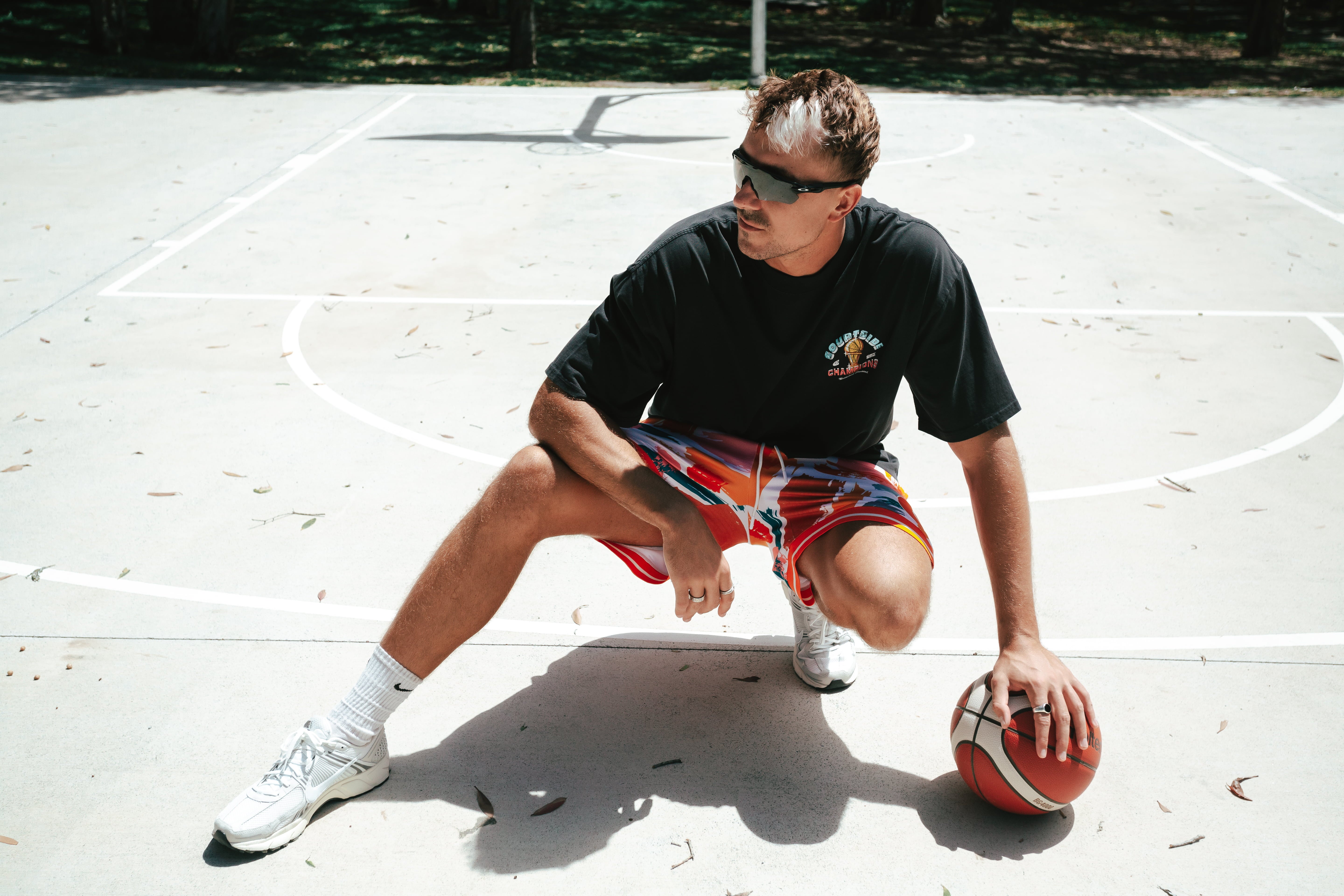 NBL Player Nelson Kahler wearing the Courtside Champs Tee in Faded Black colour.