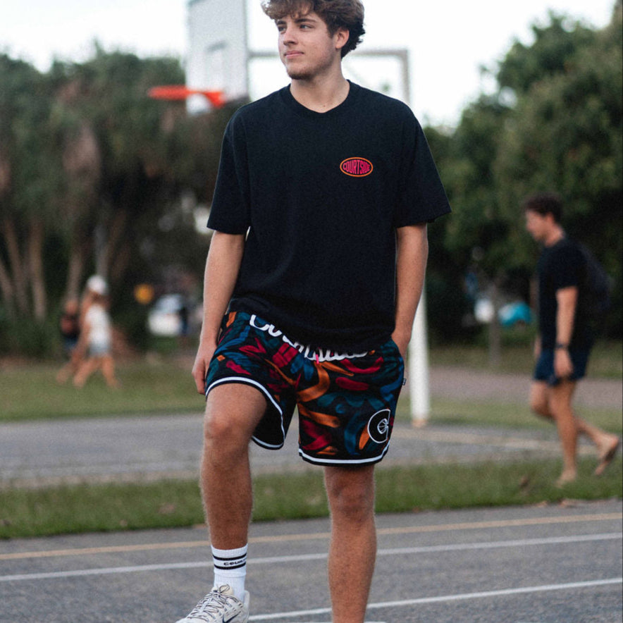 Junior elite basketball player Sam Lauret wearing Courtside ROTY black & maroon coloured patterned basketball shorts