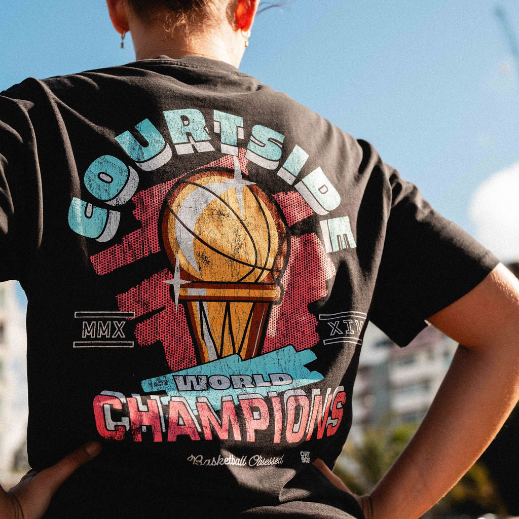 back of the champs tee shown detail on female basketball player