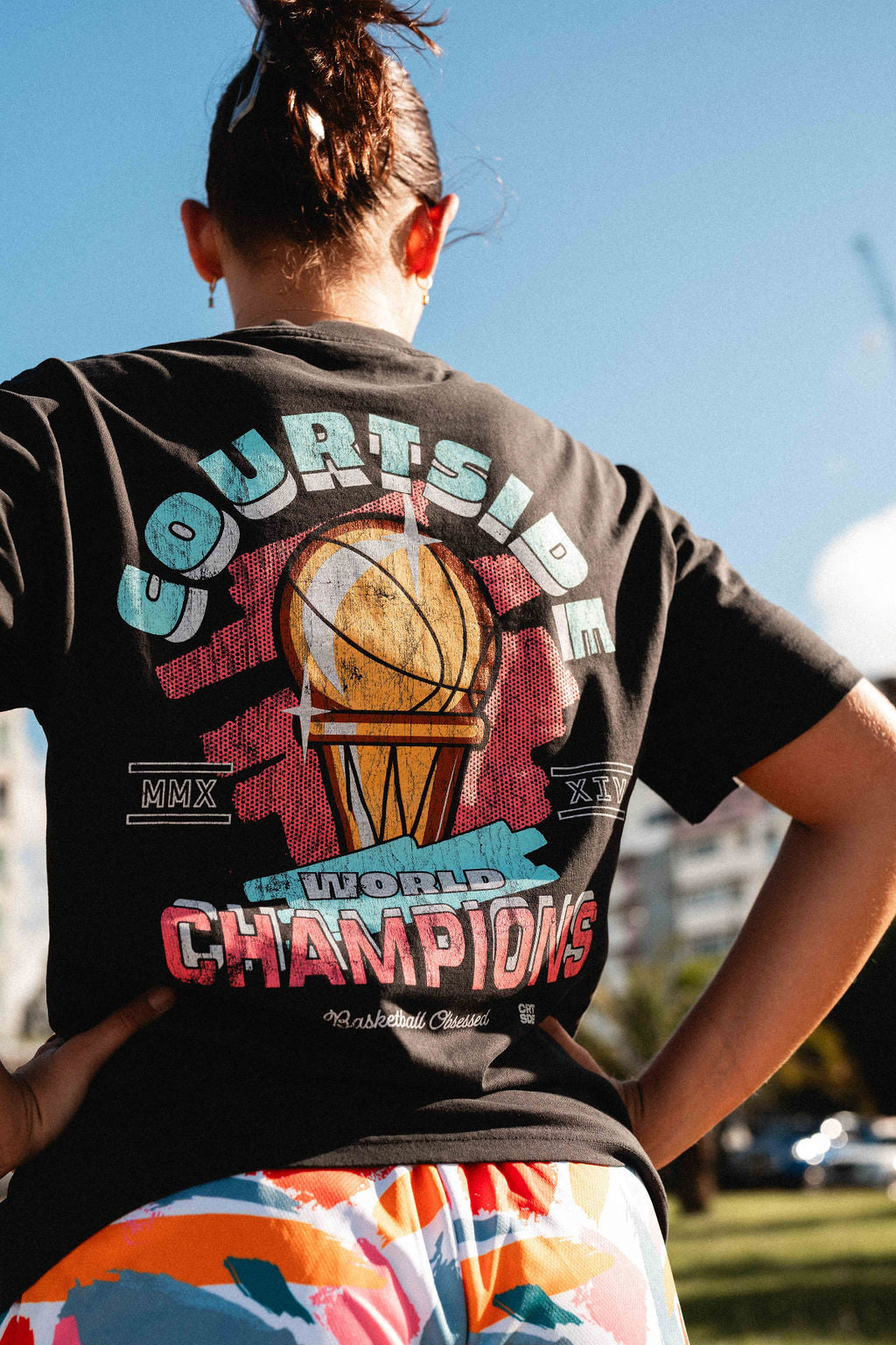 back of the champs tee shown detail on female basketball player