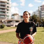 champs tee shirt showing front with female basketball player holding basketball