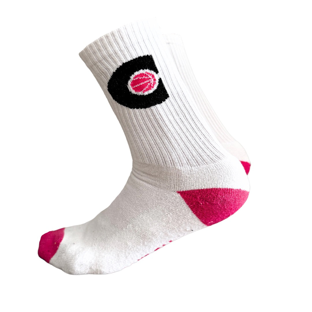 Pair of white Courtside socks with pink ball in a black C hoop logo, pink toes and heels