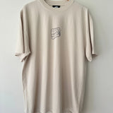 Bone t-shirt with a centre chest logo on a wooden hanger against a white background