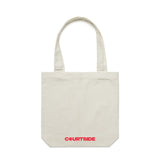 A cream tote bag with the word 'COURTSIDE' printed in red along bottom