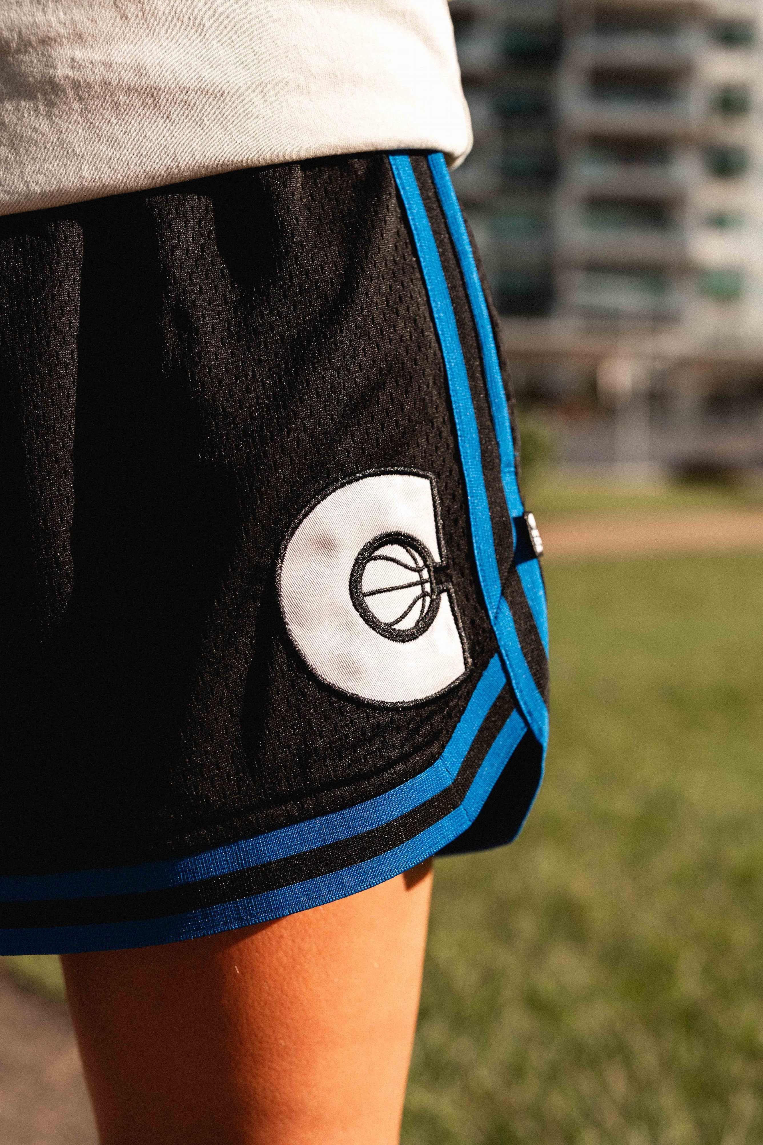 Courtside Black & Royal Blue DPOYW basketball short in women's cut showing details