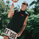 Courtside DPOY basketball shorts with CRT SDE letters in bold across front leg shown on Nelson Kahler NBL player spinning basketball on finger