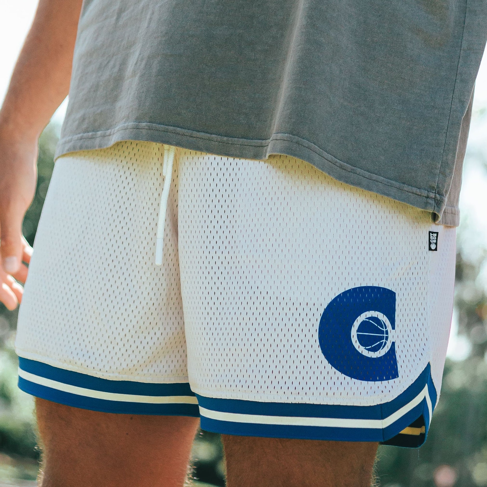 DPOY Courtside cream with royal blue detail basketball shorts shown on NBL Player Nelson Kahler 