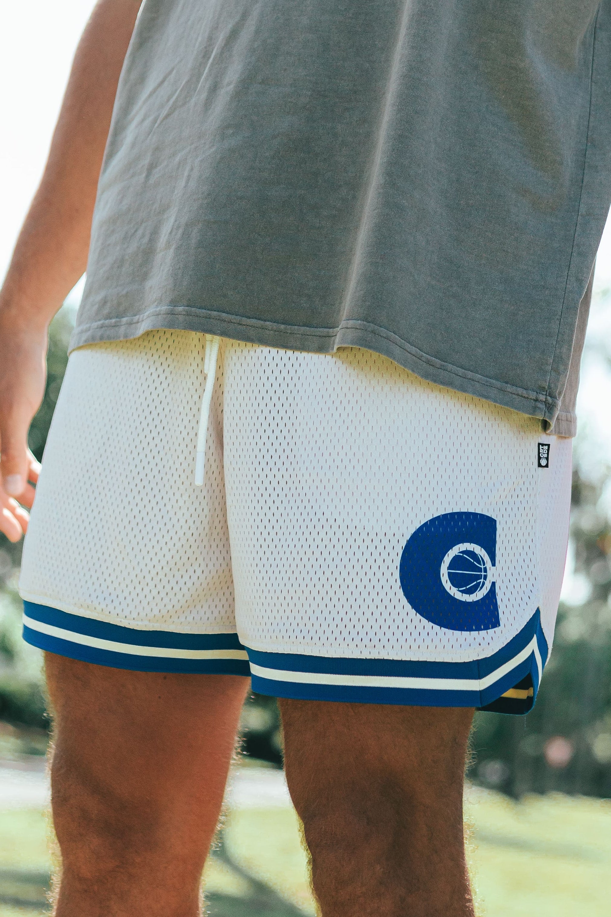 DPOY Courtside cream with royal blue detail basketball shorts shown on NBL Player Nelson Kahler 