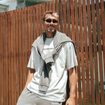 Male basketball player wearing Courtside Koby Tee in faded bone - front view showing relaxed fit