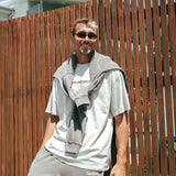 Male basketball player wearing Courtside Koby Tee in faded bone - front view showing relaxed fit