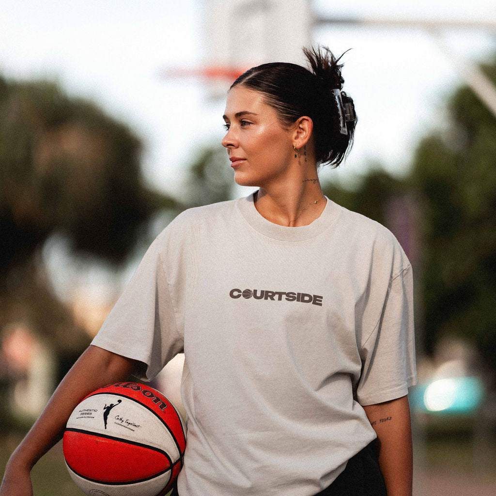 bone tshirt shown on female basketball player holding a basketball