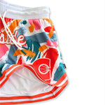 MVPW Courtside Orange and white basketball short in short women's cut flat lay showing lining and details