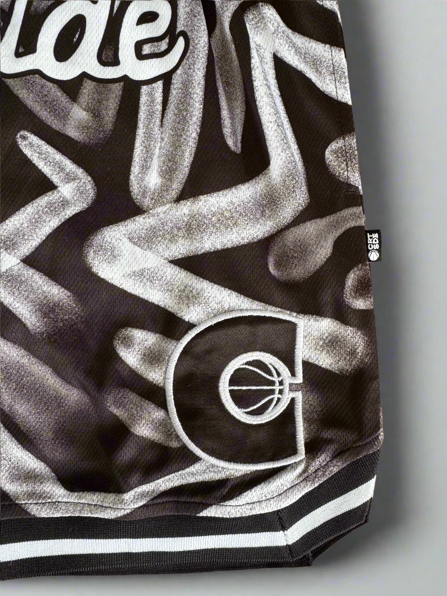 Courtside ROTY basketball shorts in white & black pattern shown up close the side details  