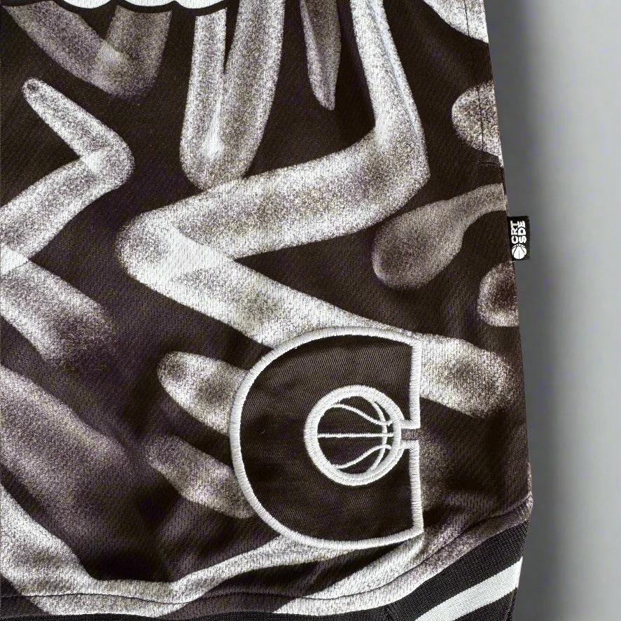Courtside ROTY basketball shorts in white & black pattern shown up close the side details  