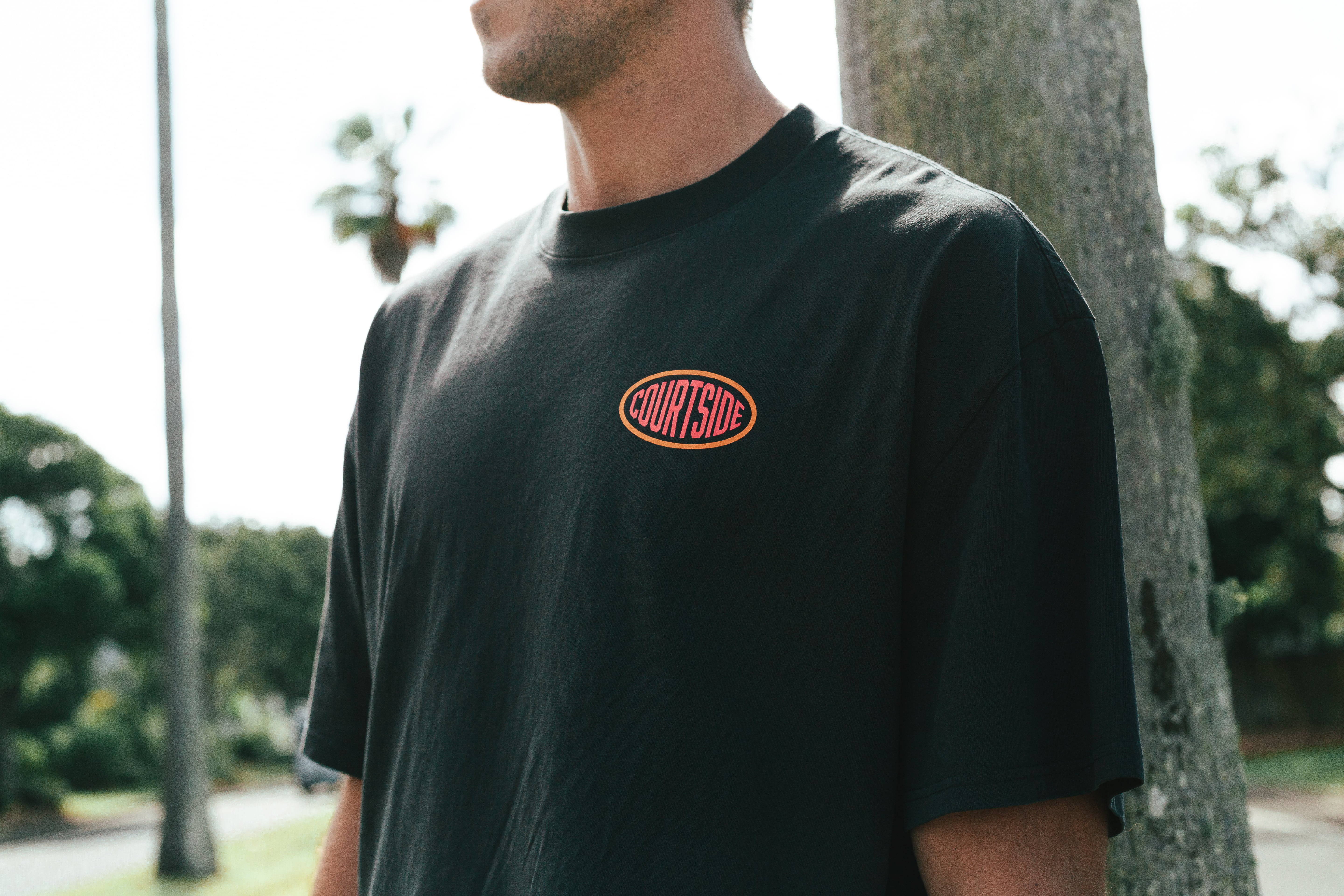 Courtside Streetball Tee in faded black - front view showing logo detail