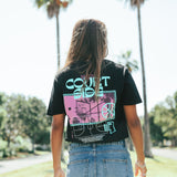 Courtside Vibes Tee in black - back view lifestyle worn by female with palm trees in background