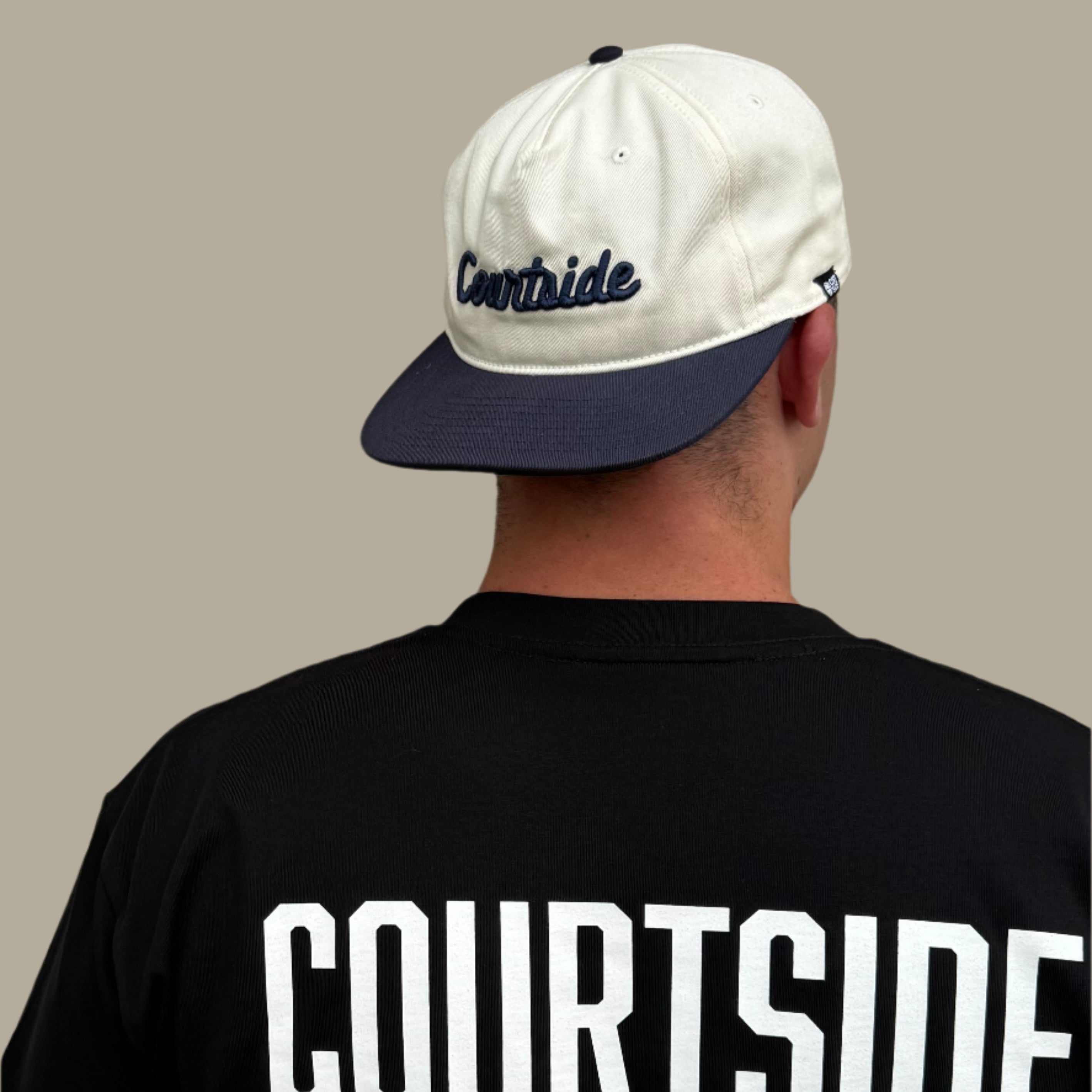 Courtside script white and navy cap showing unique style